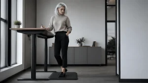 Standing at a desk on a standing mat for standing desk, an example setup from a buying guide comparing anti-fatigue mat options.